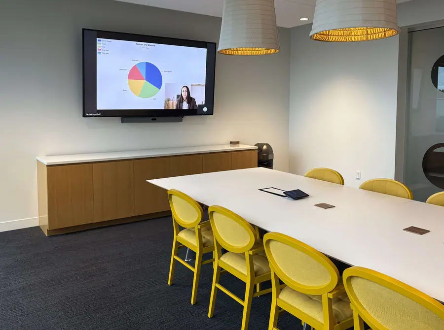 Conference room with a wall display running a video call
