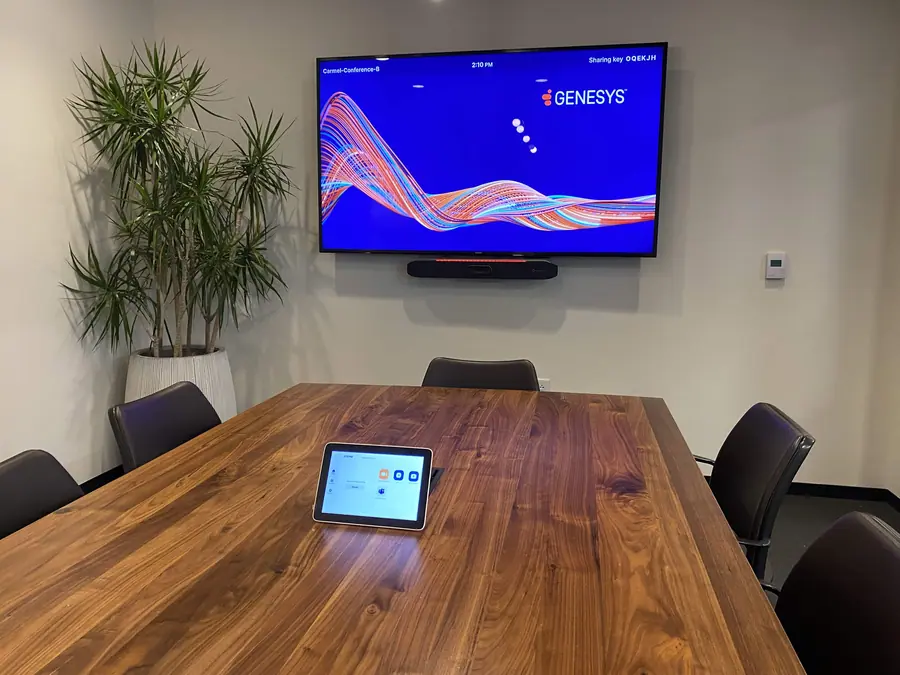 Small conference room with a wall display and a tabletop touch controller