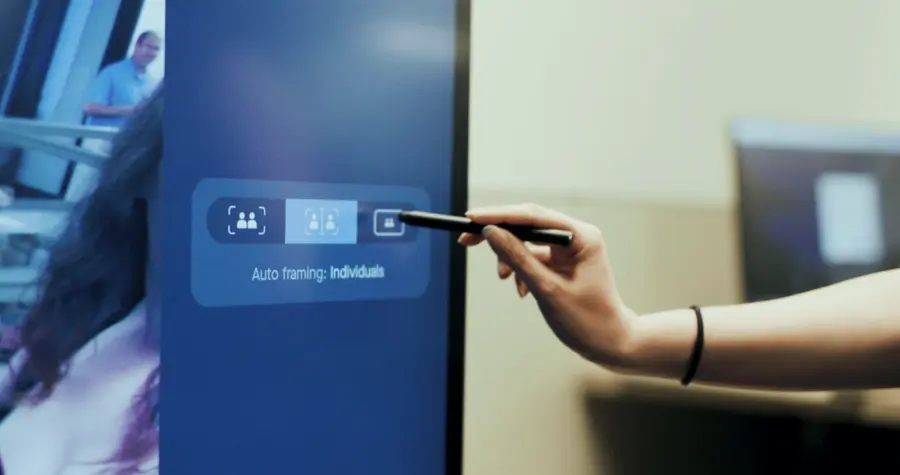 Touch controller showing camera framing options in a meeting room