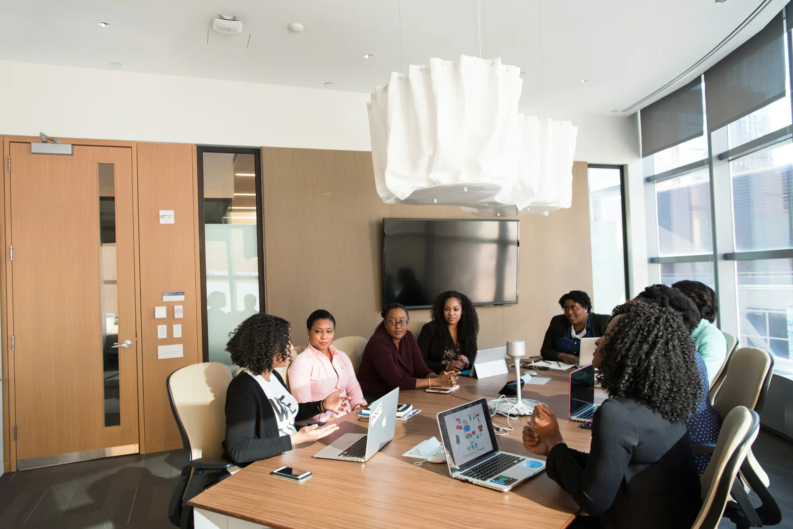 Boardroom team meeting with laptops