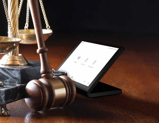 Courtroom control touch panel beside a gavel