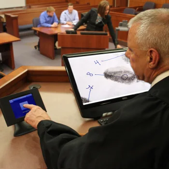 Judge presenting evidence on a tablet